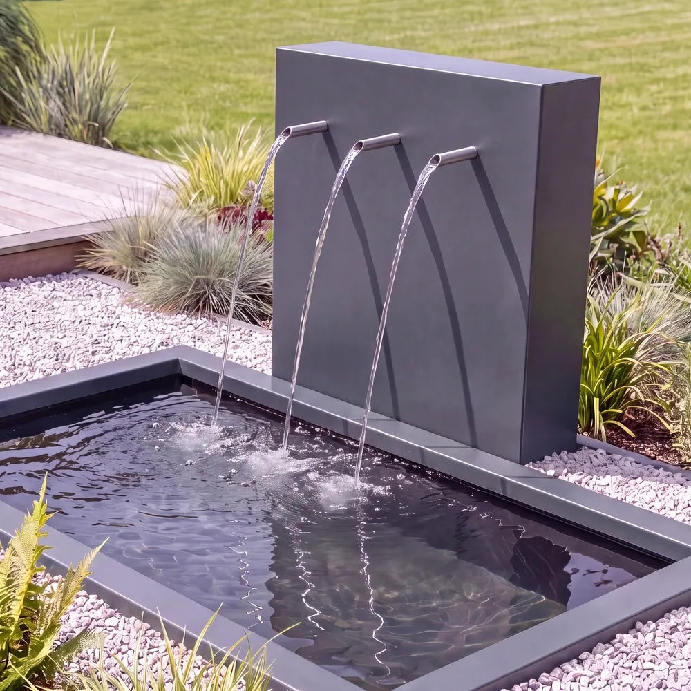 Metall-Wasserspiel mit einer Teichwand und Einlauf-Rohren mit einem im Boden versenktem GFK-Teichbecken.